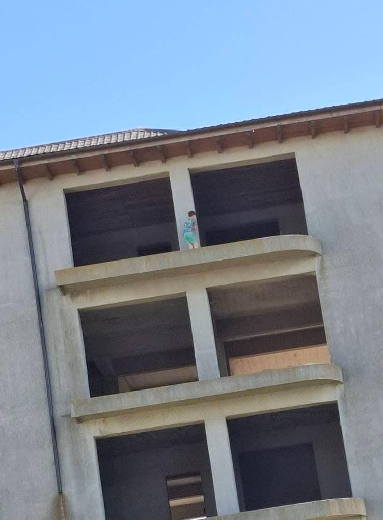 Imagini șocante! Copii surprinși jucându-se pe balcoanele unui bloc neterminat din Techirghiol